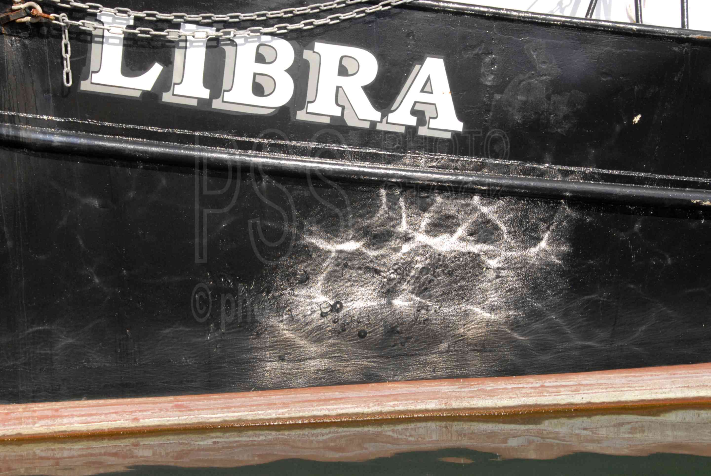 Reflections on a Boat Hull,boat,hull,water,waterfront,docks,harbor,wharf,reflection,reflections,boat,fishing boat