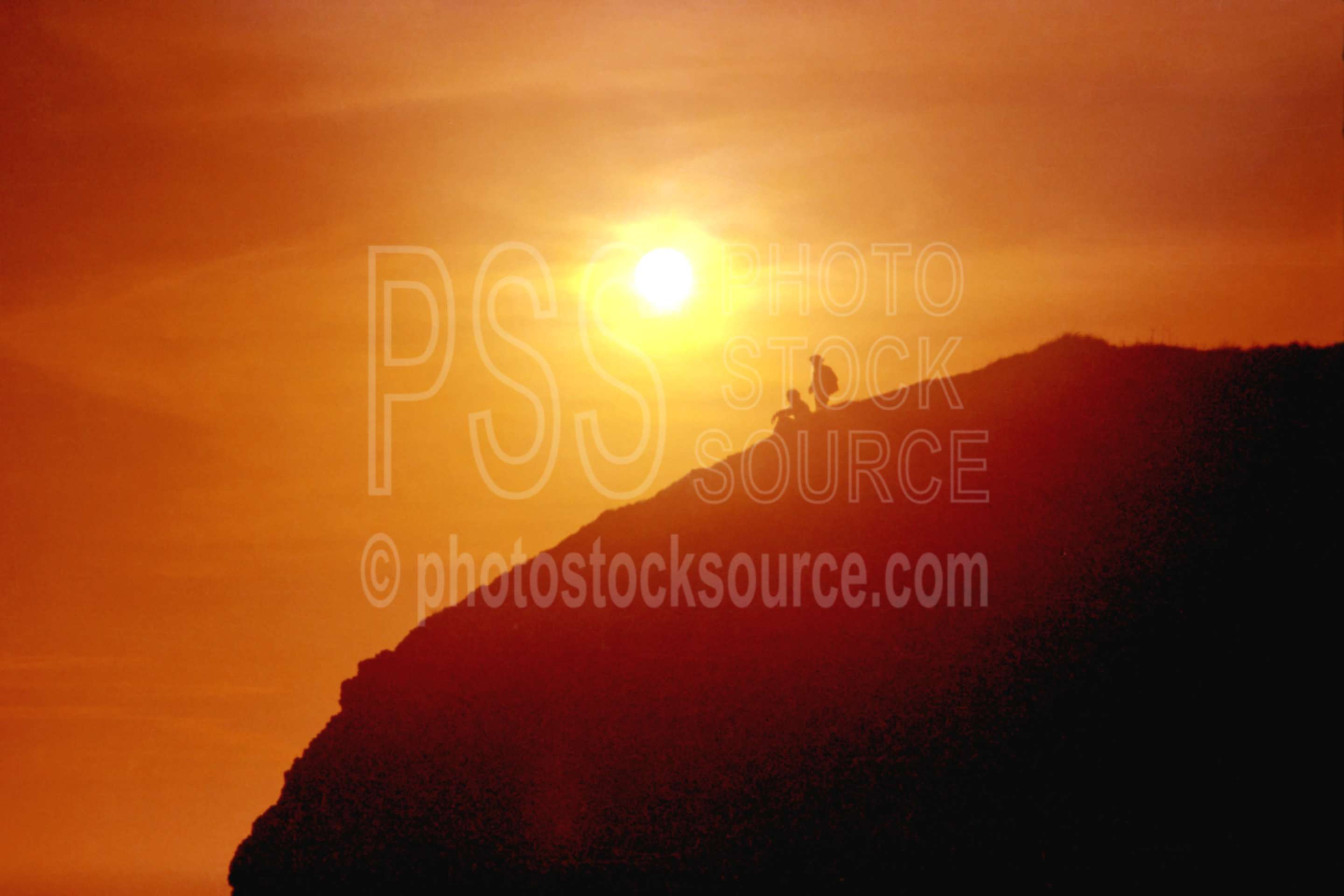 Men on Rock at Sunset,people,rock,silhouette,sunset,usas,nature,seascapes,coast