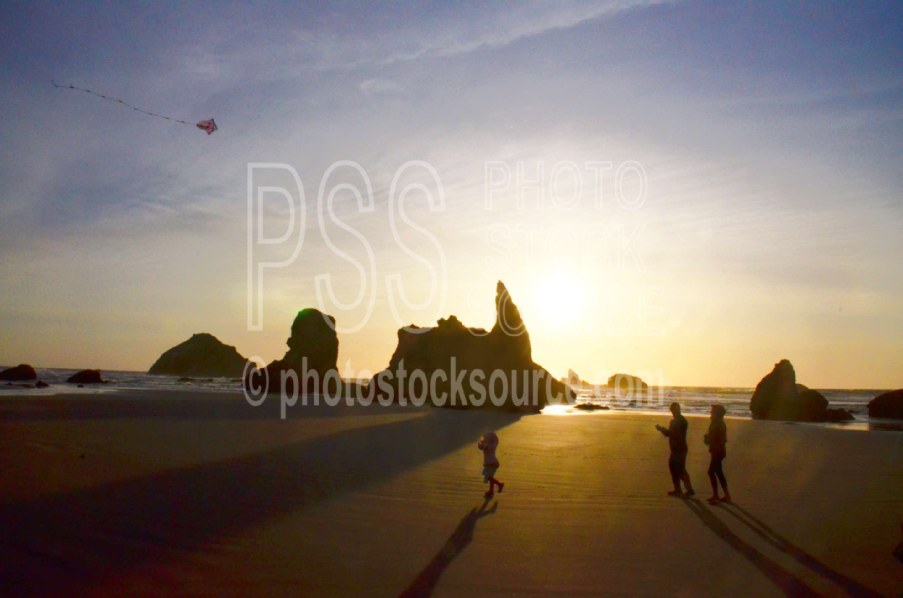 Family Flying Kite on Beach,beach,kite,flying,family,people,playing,rocks,sunset