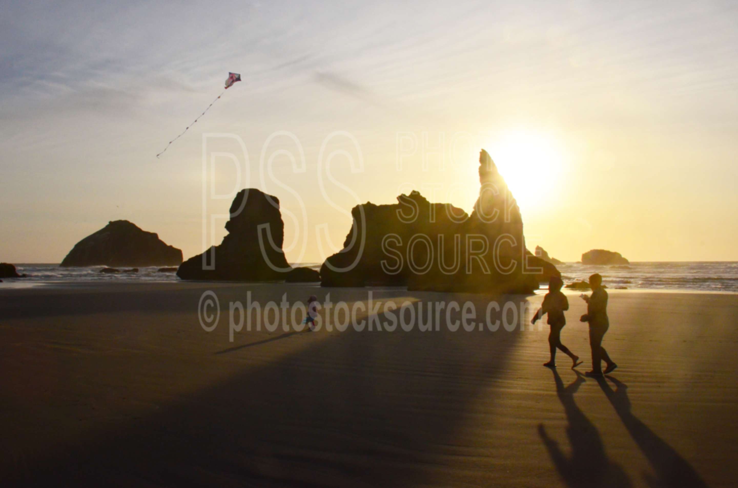 Family Flying Kite on Beach,beach,kite,flying,family,people,playing,rocks,sunset