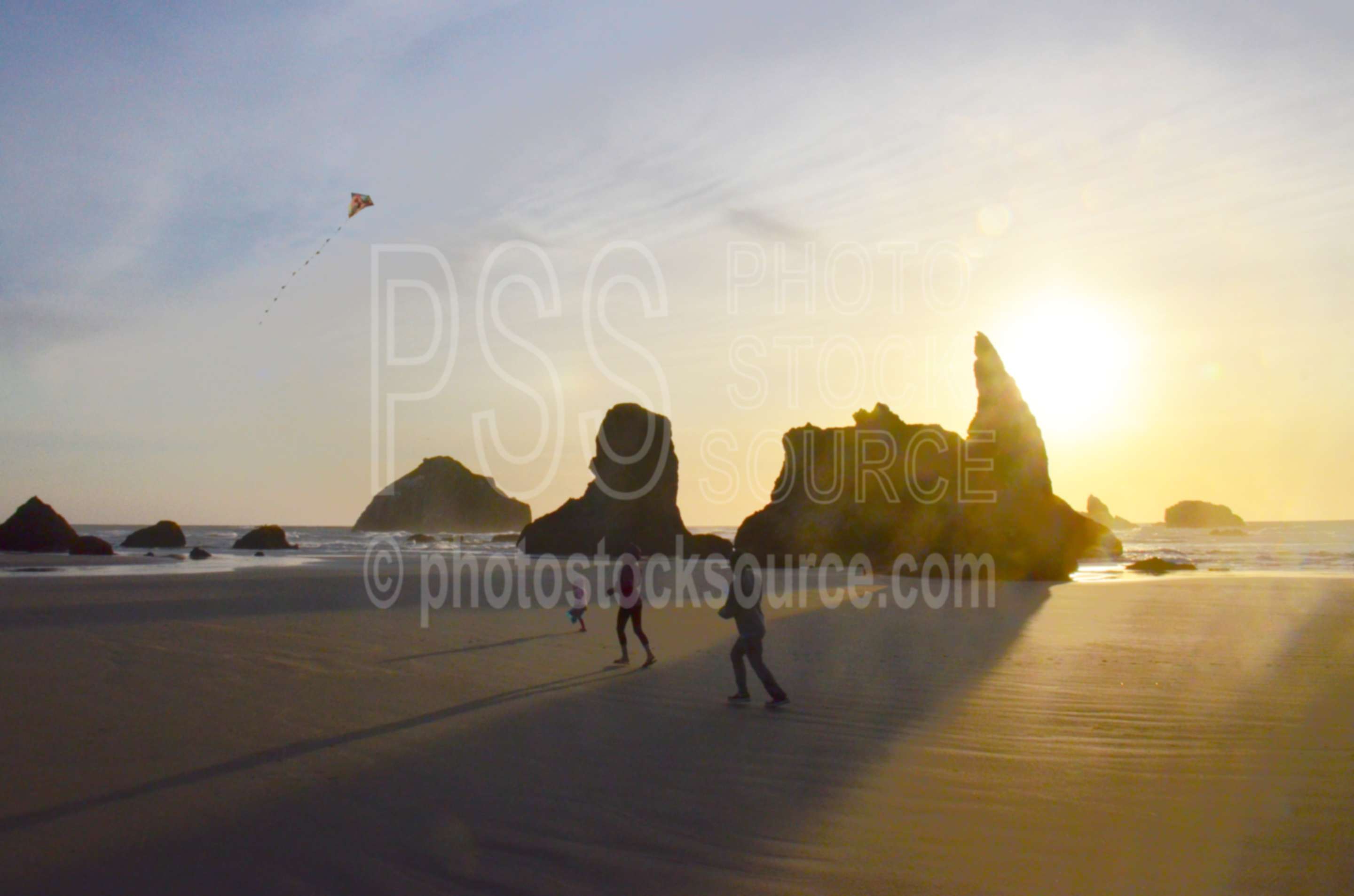 Family Flying Kite on Beach,beach,kite,flying,family,people,playing,rocks,sunset